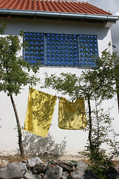 Re-Using 5litre BottlesWhen rain or high winds threaten the window panels are quickly lifted in to place to provide extra shelter from the elements.