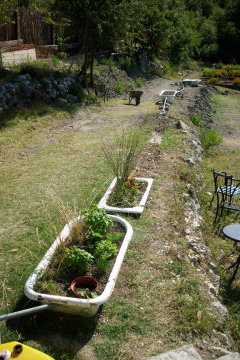 Grey Water SystemAll the used water from our showers and sinks is filtered through planted reclaimed tin baths before being re-used to water the grounds.